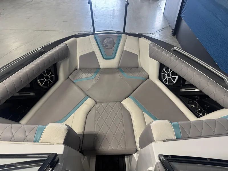 Slide: The Image of 2019 Tigé ZX1 boat interior with gray and teal cushioned seating. - 13