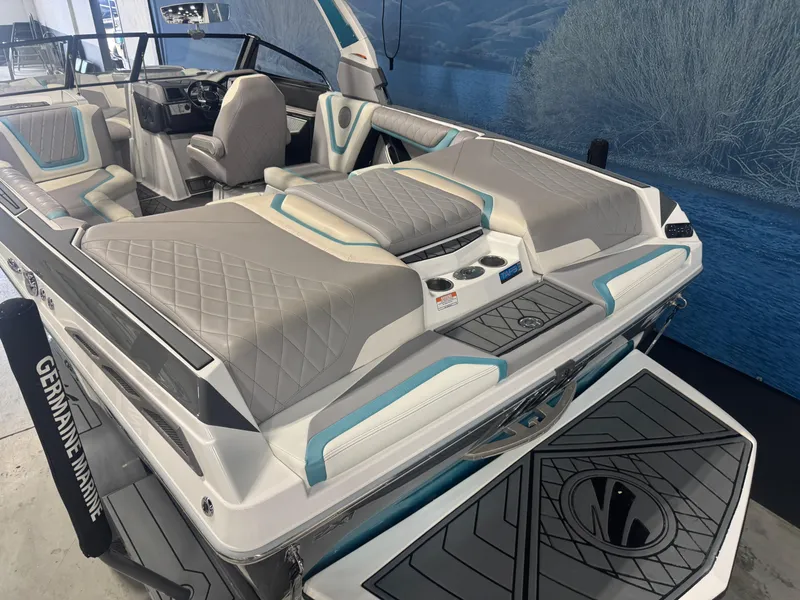 Slide: The Image of 2019 Tigé ZX1 boat interior with gray and teal seating, cup holders, and sleek design. - 5