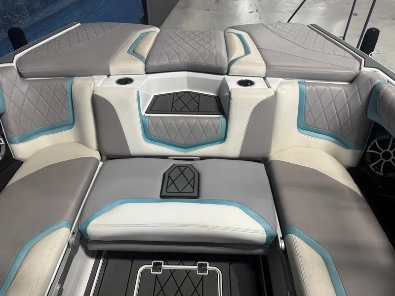 Slide: The Image of 2019 Tigé ZX1 boat interior with gray and blue cushioned seating. - 8