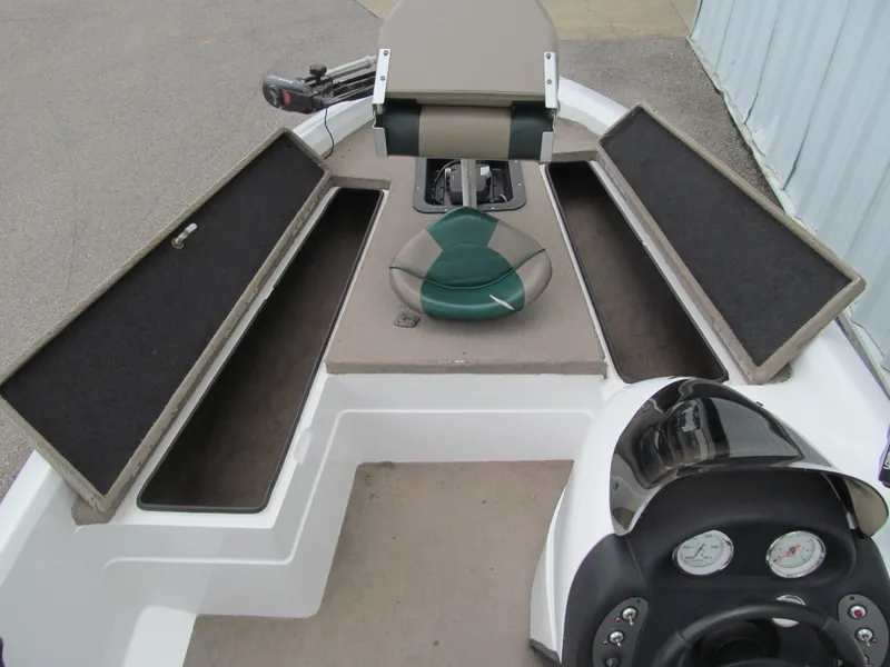 Slide: The Image of 2006 Nitro 640 LX boat interior with open storage compartments and steering console. - 5