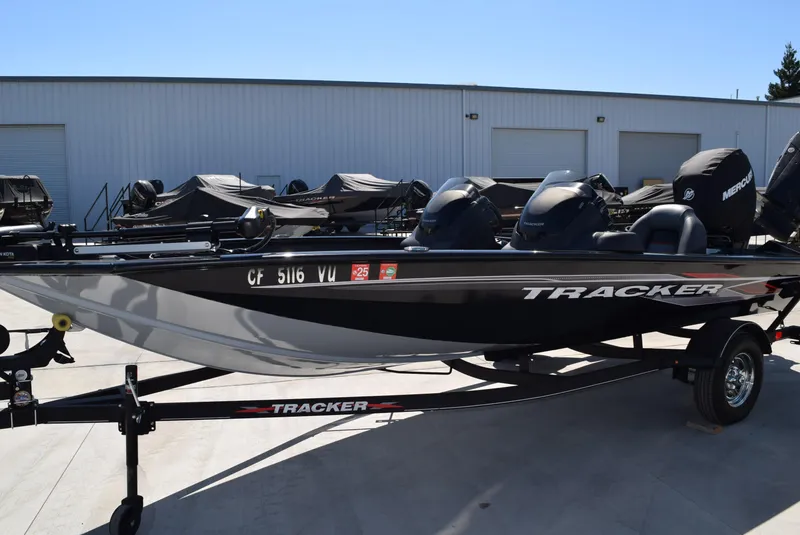 Slide: The Image of 2022 Tracker Pro Team 175 TXW boat on trailer, parked outdoors. - 2