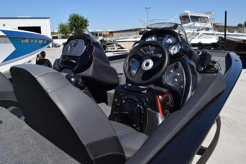 Slide: The Image of 2022 Tracker Pro Team 175 TXW boat interior with steering wheel and dashboard controls. - 5