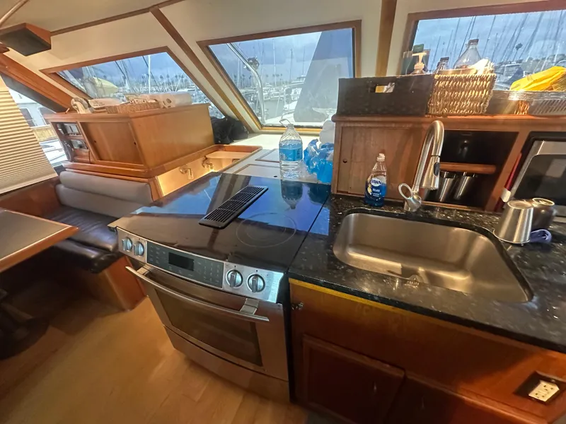 Slide: The Image of 1986 Egg Harbor SPORT FISHER yacht kitchen with modern appliances and wooden cabinetry. - 1