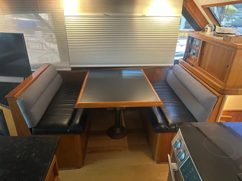 Slide: The Image of Interior of 1986 Egg Harbor SPORT FISHER yacht with dining area and wooden cabinetry. - 10
