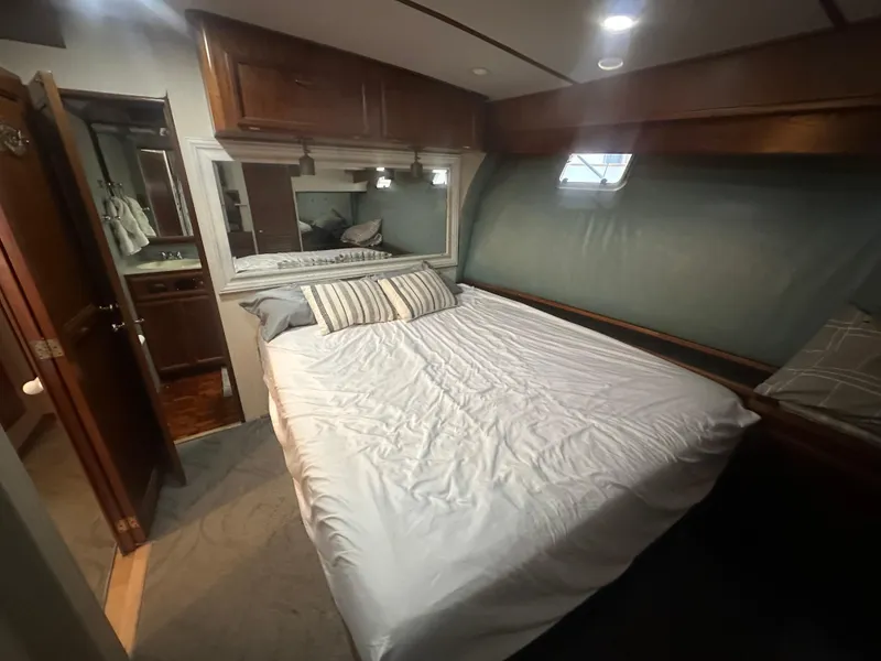 Slide: The Image of Cozy bedroom in 1986 Egg Harbor SPORT FISHER yacht with wood accents and soft lighting. - 11