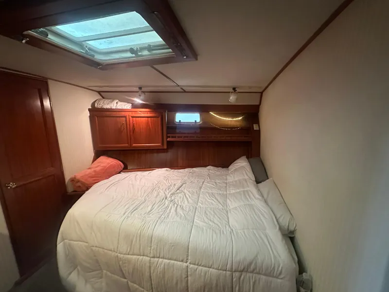 Slide: The Image of Cozy cabin interior of 1986 Egg Harbor SPORT FISHER with bed and wooden cabinetry. - 14