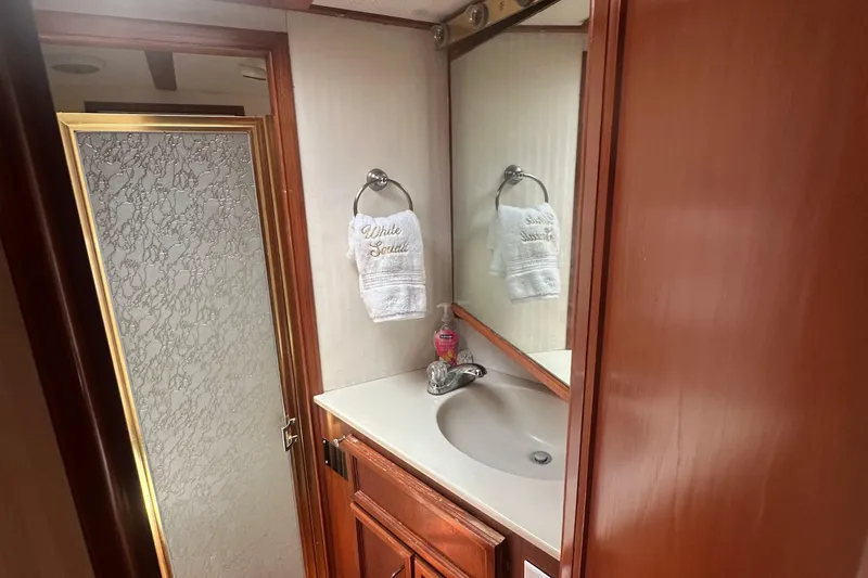 Slide: The Image of Bathroom interior of 1986 Egg Harbor SPORT FISHER with sink, mirror, and shower. - 16