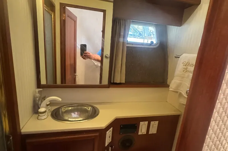 Slide: The Image of 1986 Egg Harbor SPORT FISHER bathroom with sink, mirror, and window. - 17