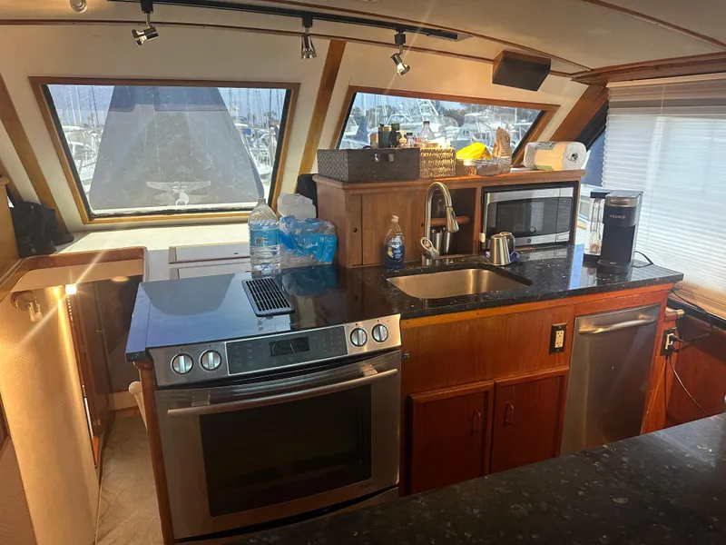 Slide: The Image of 1986 Egg Harbor SPORT FISHER yacht kitchen with modern appliances and panoramic windows. - 2