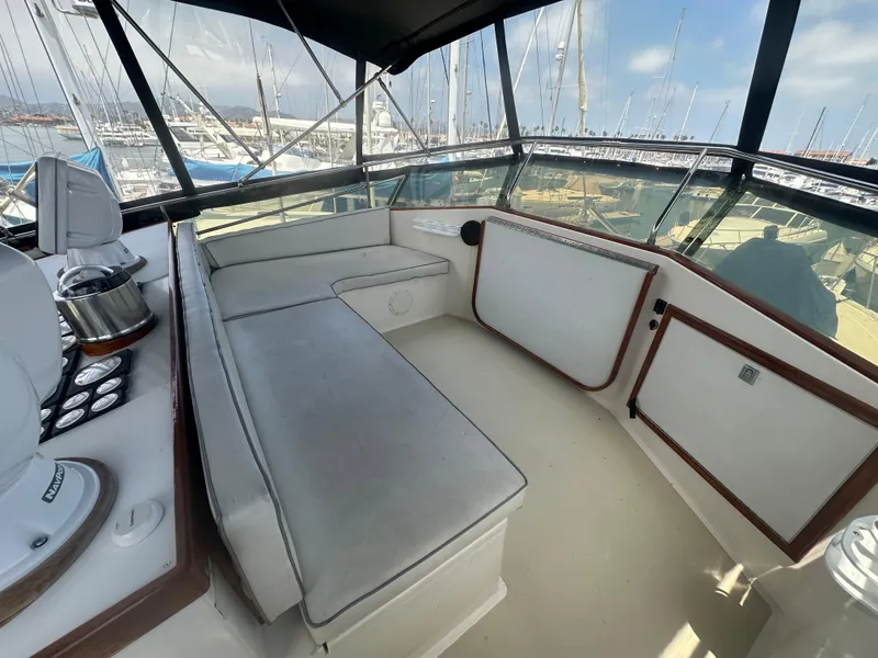 Slide: The Image of 1986 Egg Harbor SPORT FISHER interior with cushioned seating and marina view. - 21