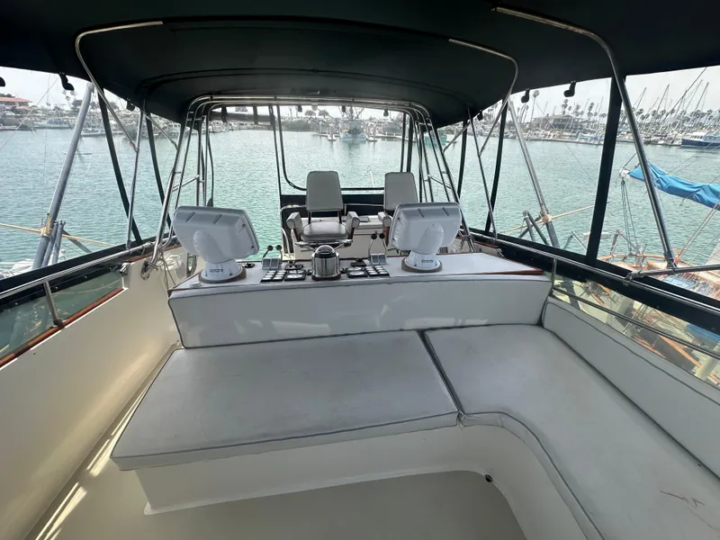 Slide: The Image of 1986 Egg Harbor SPORT FISHER boat interior with helm, seating, and marina view. - 22