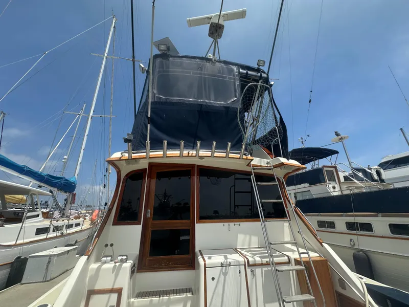 Slide: The Image of 1986 Egg Harbor SPORT FISHER boat docked at marina, view of stern and upper deck. - 24
