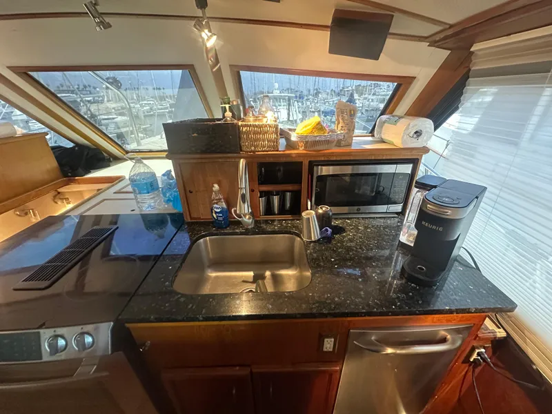 Slide: The Image of 1986 Egg Harbor SPORT FISHER yacht kitchen with sink, microwave, and coffee maker. - 3