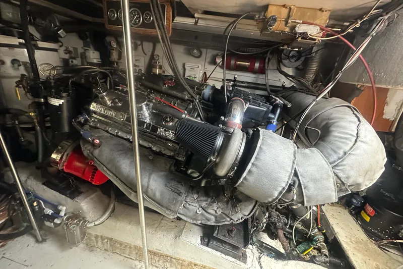 Slide: The Image of Engine room of a 1986 Egg Harbor SPORT FISHER boat, showcasing complex machinery and components. - 30