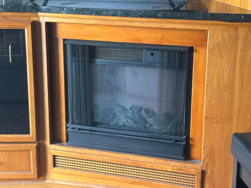 Slide: The Image of Wood-paneled fireplace inside a 1986 Egg Harbor SPORT FISHER boat. - 7