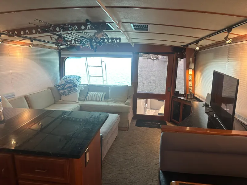 Slide: The Image of Interior of 1986 Egg Harbor SPORT FISHER yacht with cozy seating and fishing rods. - 8