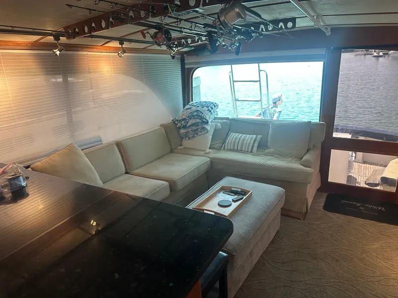 Slide: The Image of Interior of 1986 Egg Harbor SPORT FISHER yacht with cozy seating and waterfront view. - 9