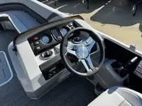 Slide: The Image of 2025 Bennington 25 SXSR boat dashboard with steering wheel and control panel. - 12