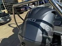 Slide: The Image of 2025 Bennington 25 SXSR boat with Yamaha 250 engine in a dealership lot. - 17