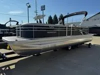 Slide: The Image of 2025 Bennington 25 SXSR pontoon boat on trailer, parked outdoors. - 3