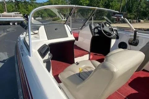 Slide: The Image of 2000 ProCraft 170 Combo boat interior with red carpet and beige seating. - 5