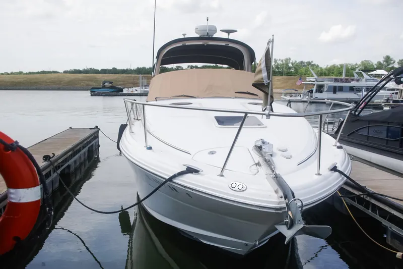 Slide: The Image of 2002 Sea Ray 300 Sundancer docked at marina, front view. - 2