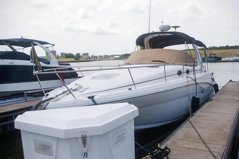Slide: The Image of 2002 Sea Ray 300 Sundancer docked at marina, side view. - 3