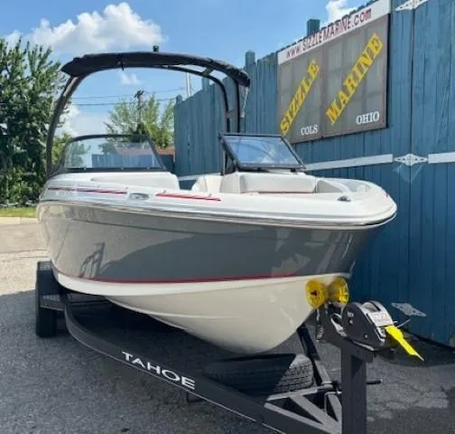 Slide: The Image of 2021 Tahoe 700 boat on trailer at Sizzle Marine dealership, sunny day. - 1
