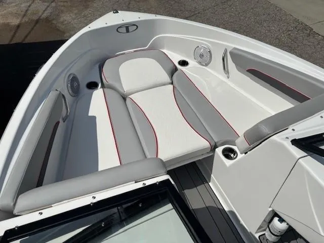 Slide: The Image of 2021 Tahoe 700 boat interior with white and gray seating, red accents, and cup holders. - 11