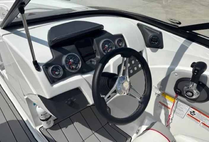 Slide: The Image of Dashboard of a 2021 Tahoe 700 boat with steering wheel and control panel. - 14