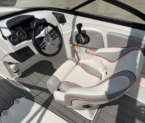 Slide: The Image of Cockpit of 2021 Tahoe 700 boat with steering wheel and captain's chair. - 16