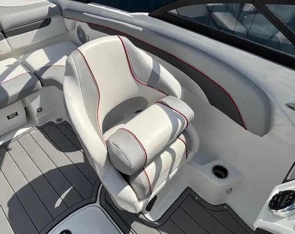 Slide: The Image of Captain's seat on 2021 Tahoe 700 boat, featuring white upholstery with red accents. - 21