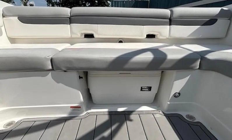 Slide: The Image of 2021 Tahoe 700 boat interior with gray and white seating and storage compartment. - 24