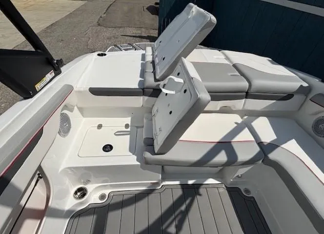 Slide: The Image of 2021 Tahoe 700 boat interior with open storage compartments and cushioned seating. - 25