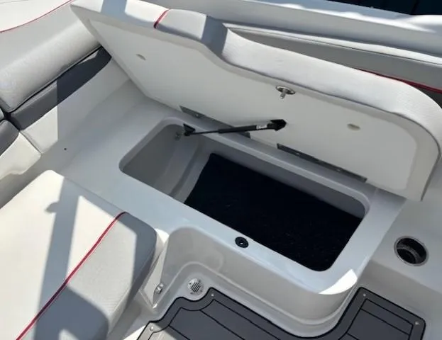 Slide: The Image of 2021 Tahoe 700 boat storage compartment with open lid and cushioned seating. - 27