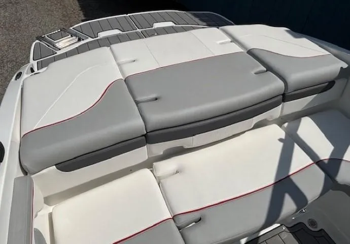 Slide: The Image of 2021 Tahoe 700 boat interior with gray and white cushioned seating. - 28