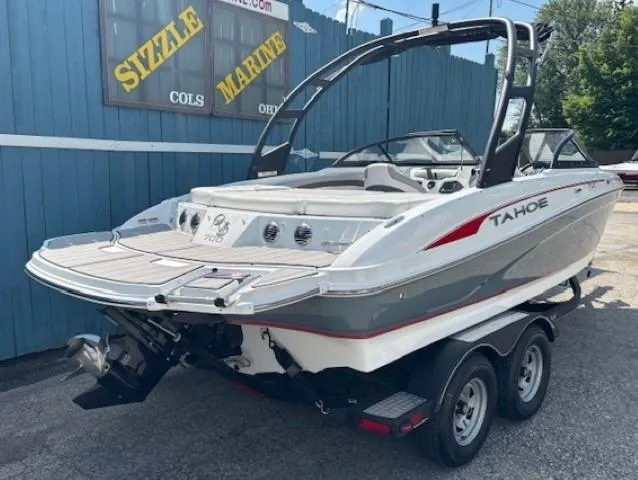 Slide: The Image of 2021 Tahoe 700 boat on trailer, parked outside Sizzle Marine dealership. - 3