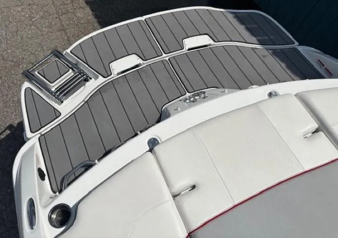 Slide: The Image of 2021 Tahoe 700 boat deck with gray and white seating, featuring a swim platform and ladder. - 31