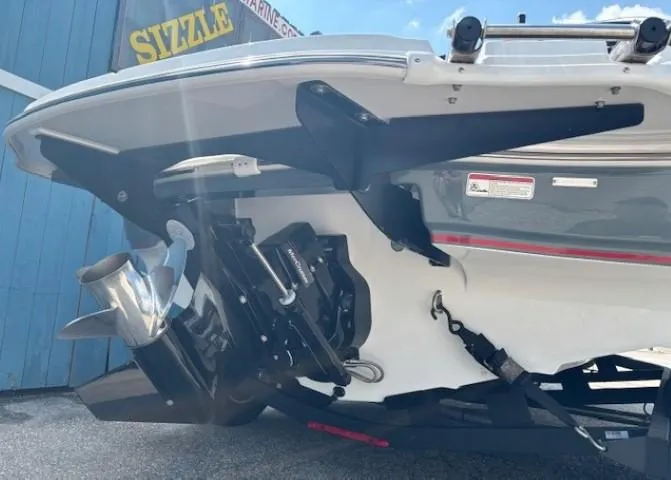 Slide: The Image of 2021 Tahoe 700 boat stern with motor and propeller, parked outdoors. - 5