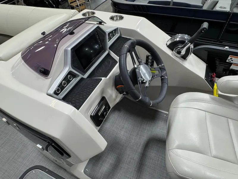 Slide: The Image of 2020 Manitou 23 Oasis RF boat dashboard with steering wheel and control panel. - 11