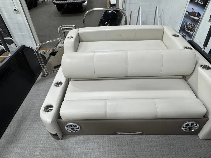 Slide: The Image of 2020 Manitou 23 Oasis RF boat interior with plush seating and cup holders. - 15