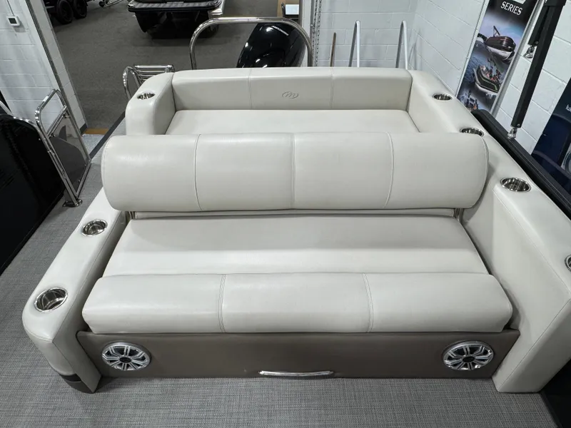 Slide: The Image of 2020 Manitou 23 Oasis RF boat interior with beige seating and cup holders. - 18