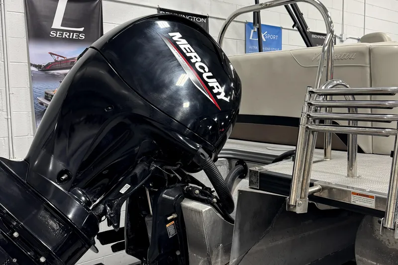 Slide: The Image of 2020 Manitou 23 Oasis RF with Mercury outboard motor in showroom. - 23