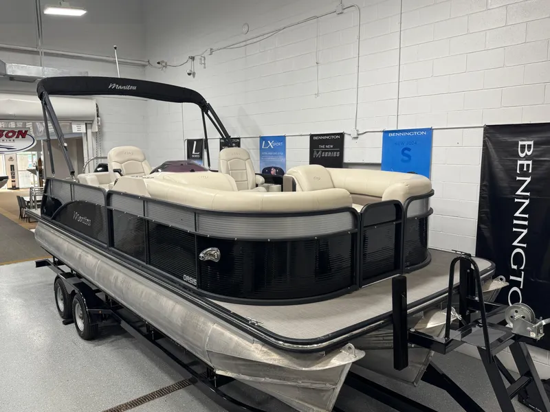 Slide: The Image of 2020 Manitou 23 Oasis RF pontoon boat displayed indoors on a trailer. - 4