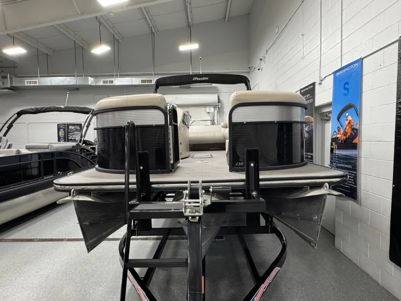 Slide: The Image of 2020 Manitou 23 Oasis RF pontoon boat displayed indoors on a trailer. - 6