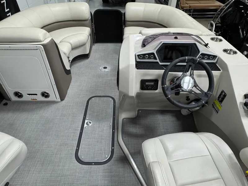 Slide: The Image of 2020 Manitou 23 Oasis RF boat interior with steering wheel and seating. - 9