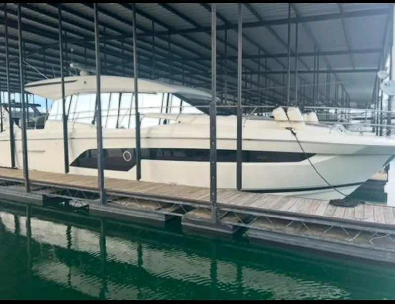 Slide: The Image of 2023 Prestige 520S yacht docked in a covered marina. - 1