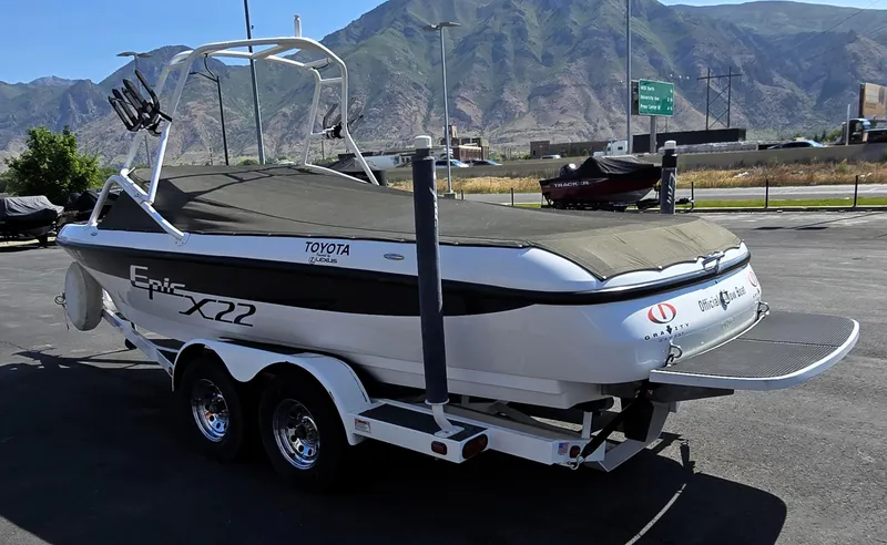 Slide: The Image of 2000 Toyota Epic 22 boat on trailer with mountain backdrop. - 6