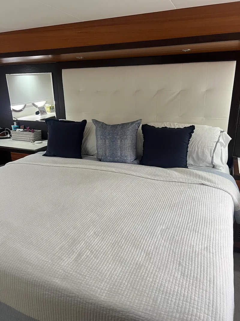 Slide: The Image of Luxurious bedroom interior of 2011 Hatteras 60 Motor Yacht with elegant bedding and cushions. - 11