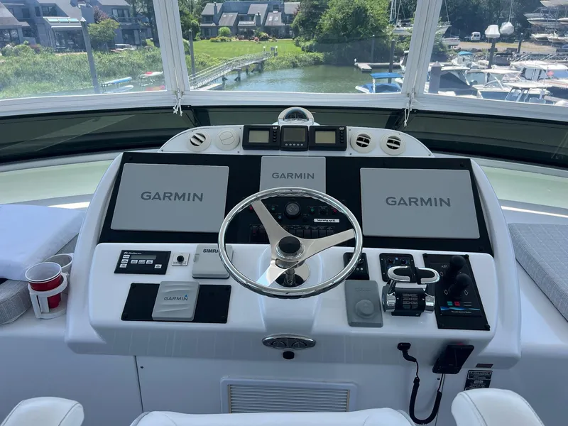 Slide: The Image of Helm of 2011 Hatteras 60 Motor Yacht with Garmin navigation displays and controls. - 15